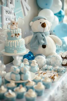 a teddy bear sitting on top of a table next to cupcakes and cakes