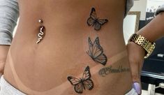 a woman's stomach with butterflies on it