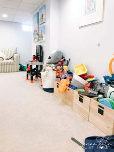 a room filled with lots of clutter and toys in bins on the floor