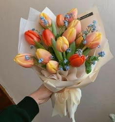 a person holding a bouquet of flowers in their hand