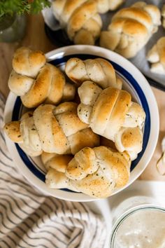 rolls are on a plate next to a bowl of ranch dressing and a jar of ranch dressing