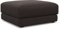 a brown ottoman sitting on top of a white floor