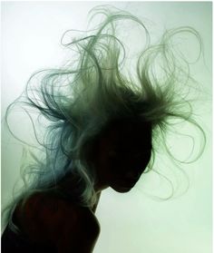 a woman with her hair blowing in the wind