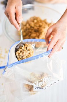 a person scooping granola out of a plastic bag with a spoon in it