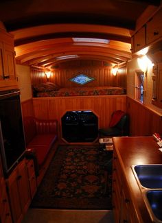 the interior of a vehicle with wood paneling and leather seats, including a couch