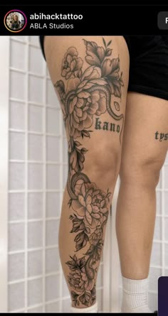 a woman's legs with tattoos and flowers on them