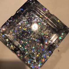 a square box filled with lots of glitter