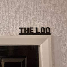 the door is open and there is a sign that says the loo on it