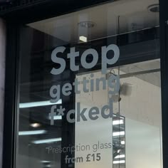 a glass window with the words stop getting f - faked on it's side