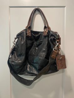 Only seen one more of these for sale! Lambskin leather large Chloe Bon Voyage tote bags, black with brown details and stitching. 5 zipper pockets (one internal) with zipper expansion on bottom of bag. Mix of gold and silver hardware, all original. Removable long strap included. Extremely good condition, minimal wear. Small smudge on Chloe tag, as seen.  Approx. Measures: 21" wide at bottom, 12" height. 7.5" drop on handles, 14" drop on shoulder strap. Never used since purchased at an auction! Insurance included $100, $200 international. Pretty When You Cry, Bags Black, City Bag, Chloe Bag, Large Tote, Lambskin Leather, Silver Hardware, Gold And Silver, Knee High Boots