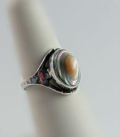 Check out this stunning vintage sterling silver ring, featuring a beautiful abalone stone set on a hammered sterling band. The band meets elegantly at the top, where the abalone stone protrudes, adding a unique touch to this size 5.75 ring. Although it is signed, the signature is hard to decipher. Weighs 2g, making it a delicate and charming addition to any jewelry collection. R2_595 Abalone Ring, Vintage Sterling Silver Rings, Stone Settings, Vintage Sterling Silver, Rings Statement, Statement Rings, Sterling Silver Rings, Halloween Shopping, Jewelry Collection