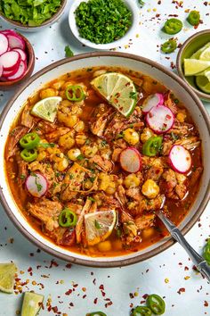 a white bowl filled with shrimp and tortilla soup next to sliced radishes