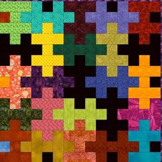 a colorful quilt with many different colored squares on the front and back, as well as an abstract design