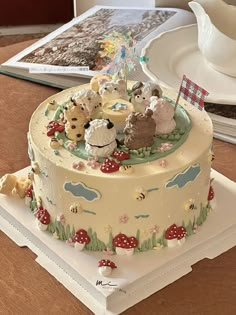 there is a cake decorated with animals on the top and in the middle, sitting on a plate