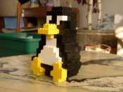 a lego penguin sitting on top of a table