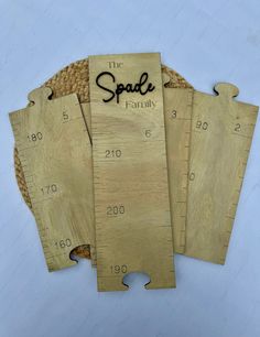 three wooden rulers with the words, the spauld family on them are laid out