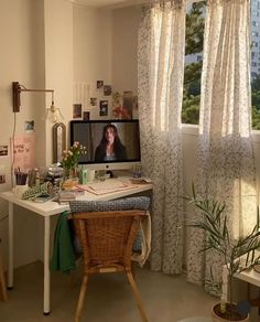 a desk with a computer monitor, keyboard and mouse on it in front of a window