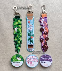 four different key chains with buttons attached to them