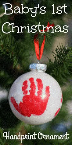 a baby's 1st christmas ornament hanging on a tree with the words handprint ornaments