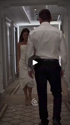 a man and woman are walking down the hallway in formal wear, one is wearing a white dress