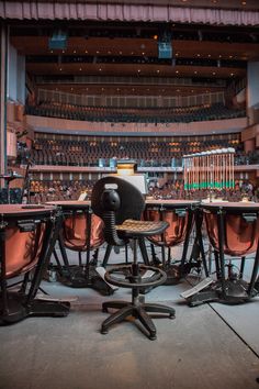 an empty concert hall with chairs and microphones