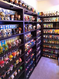 a room filled with lots of different kinds of toy figurines on shelves next to each other