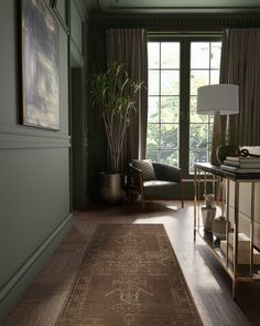 a living room filled with furniture and a large rug on top of a hard wood floor