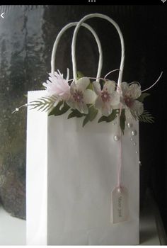 a white paper bag with flowers on it