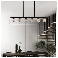 a dining room with a table and some lights hanging from the ceiling over it's head