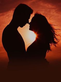 the silhouette of a man and woman kissing in front of an orange sky at sunset