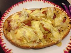 a pizza with onions and cheese on a plate