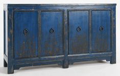 an old blue cabinet with four doors