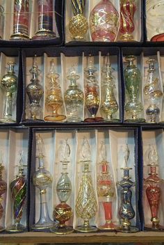 an assortment of glass perfume bottles on display