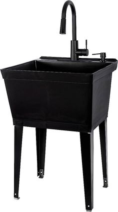 a black sink sitting under a faucet next to a faucet