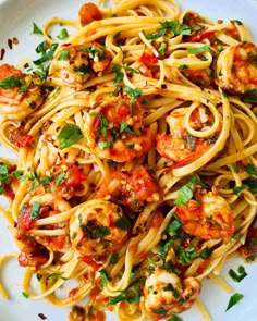 pasta with shrimp and tomato sauce on a white plate