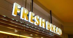 a sign that reads fresh bread on the side of a building