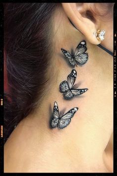 a woman's neck with three butterflies on the back of her neck and behind her ear