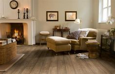 a living room filled with furniture and a fire place next to a wall mounted clock