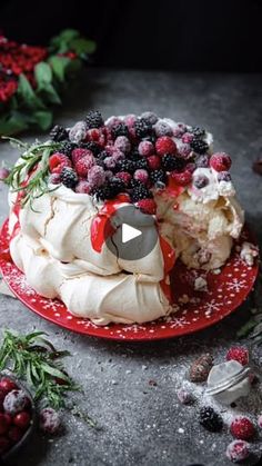 the cake is decorated with berries and icing