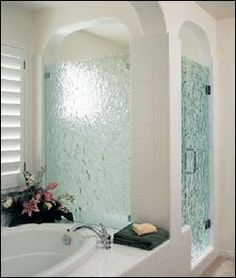 a bath tub sitting next to a walk in shower