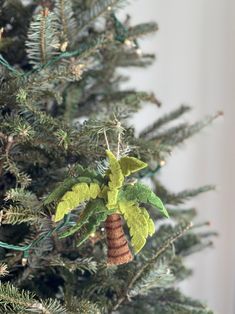 a christmas tree with a pine cone hanging from it