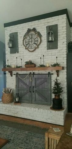 a living room filled with furniture and a clock on top of the fireplace mantel