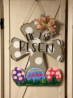 a door hanger that says he is risen with eggs and mushrooms in front of it