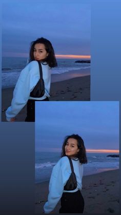 a woman standing on top of a beach next to the ocean at dusk with her hands in her pockets