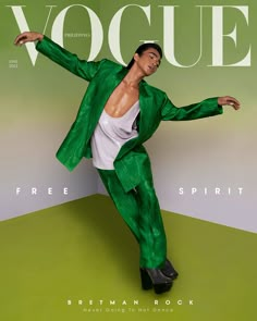 a man in a green suit and white shirt is posing on the cover of a magazine