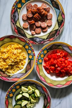 four plates filled with different types of food on top of a table next to each other