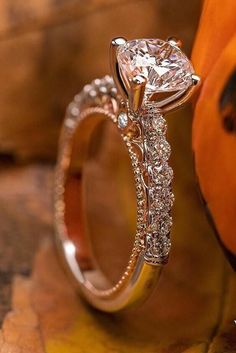 a diamond ring sitting on top of a pumpkin