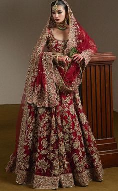 a woman in a red and gold wedding dress