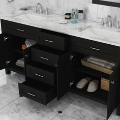 a bathroom vanity with two sinks and black cabinetry on the countertop is shown