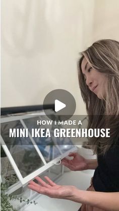 a woman is looking at plants in a greenhouse with the words how i made a mini ikea greenhouse